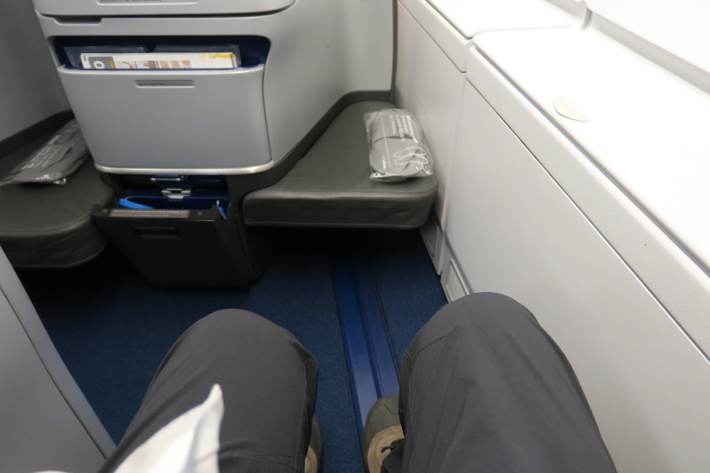 a person's legs in a seat on an airplane