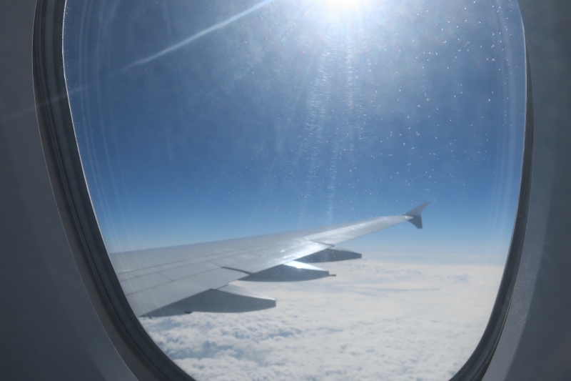 a wing of an airplane above clouds