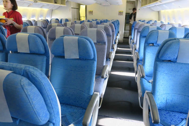 a row of blue seats in an airplane