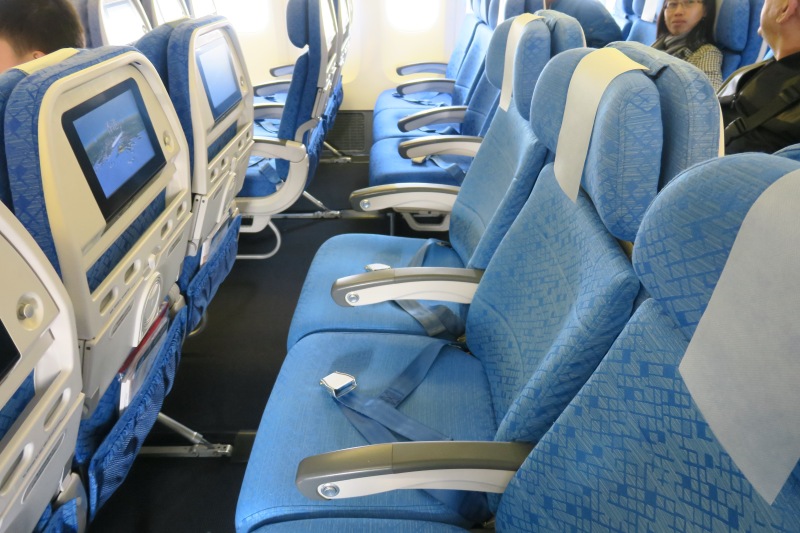 a row of blue seats in an airplane