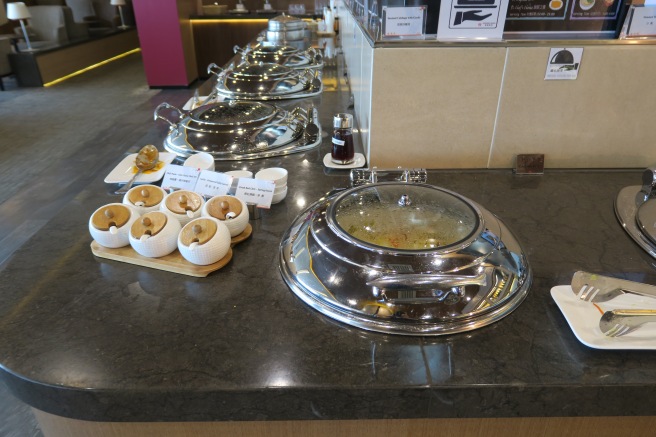 a row of silver containers on a counter