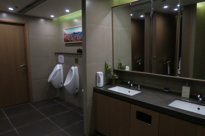 a bathroom with urinals and sinks