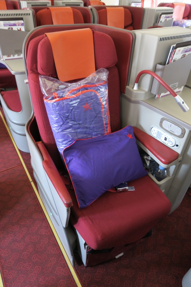 a seat with a pillow and a bag on it