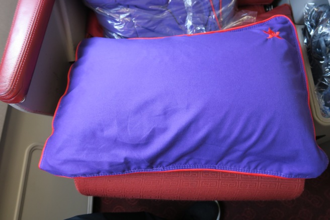 a purple pillow with a red star on it