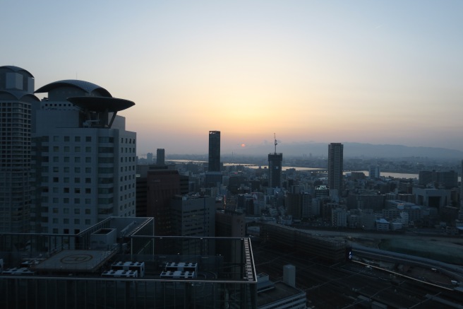 a city skyline with a sunset