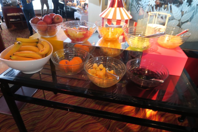 a table with bowls of fruit