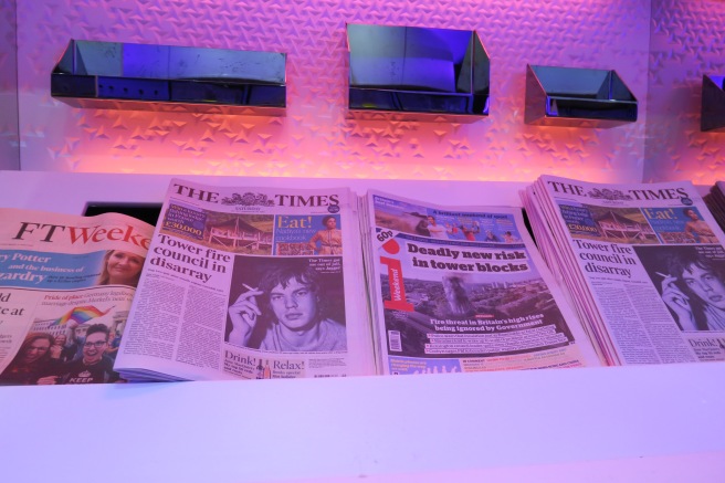 a group of newspapers on a shelf