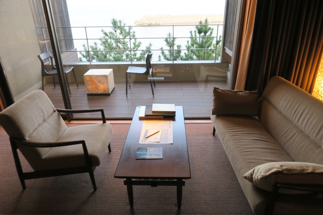 a living room with a coffee table and chairs