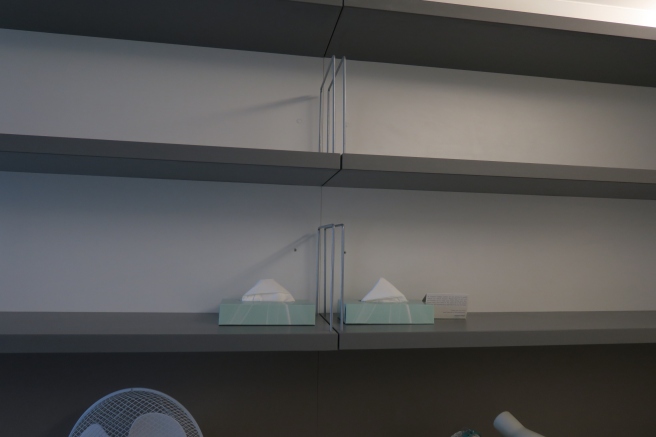 a shelf with a few napkins on it