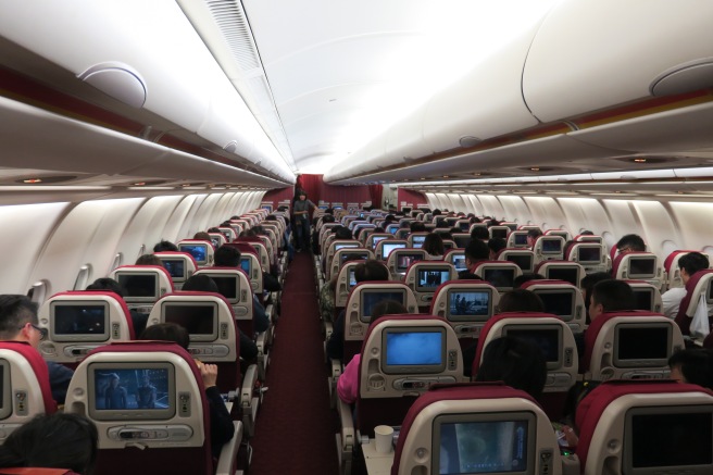 a group of people sitting in an airplane