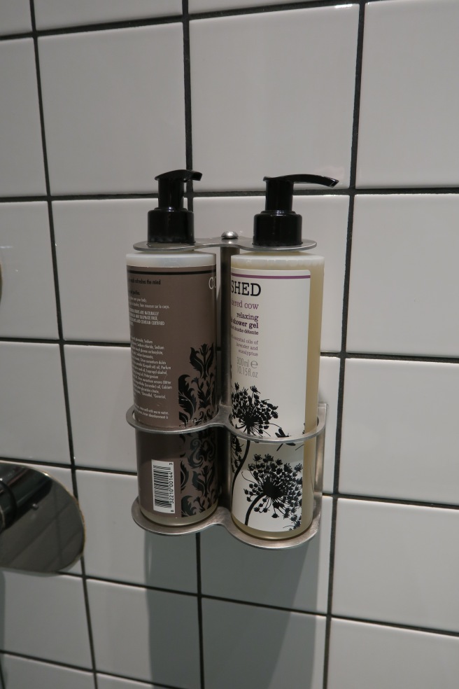 a group of bottles of shampoo and conditioner on a wall