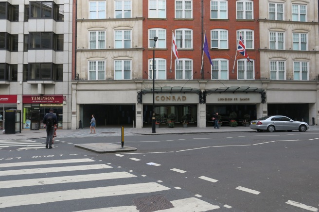 a street with flags on the front of a building