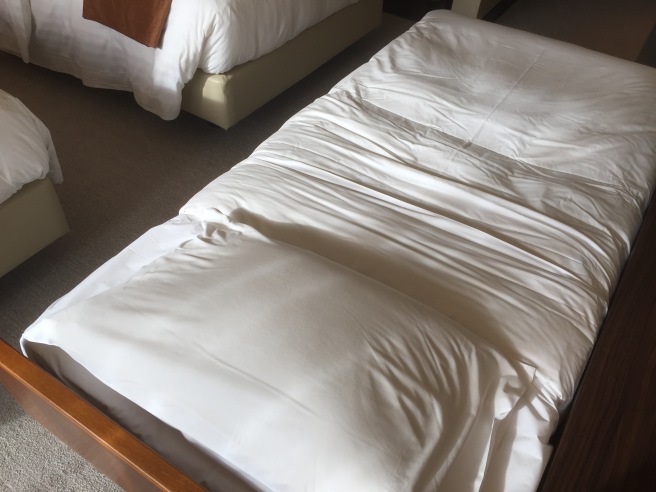 a bed with a white sheet