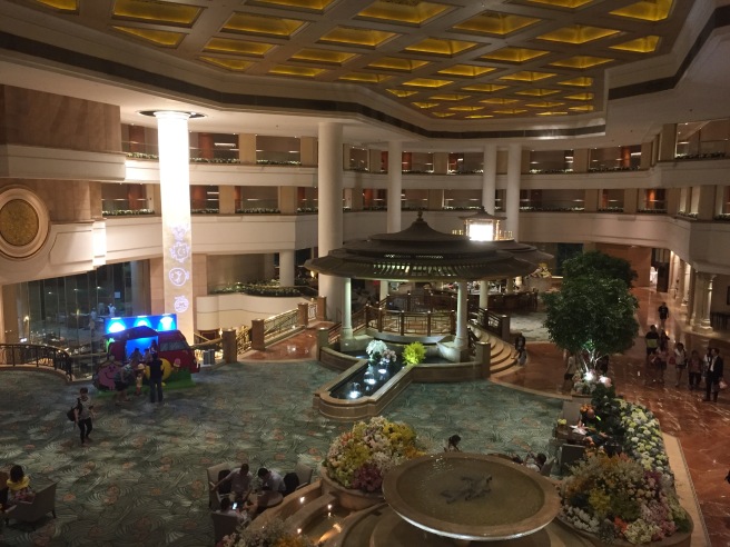 a large building with a fountain and people in it