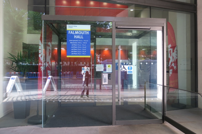 a glass door with a person walking in it