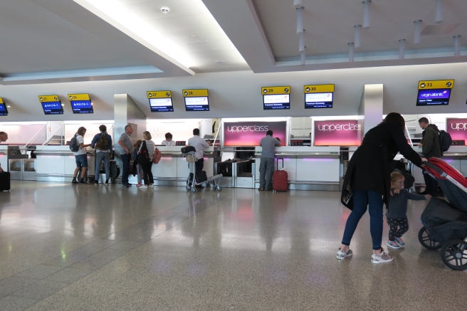 people standing in a line at an airport