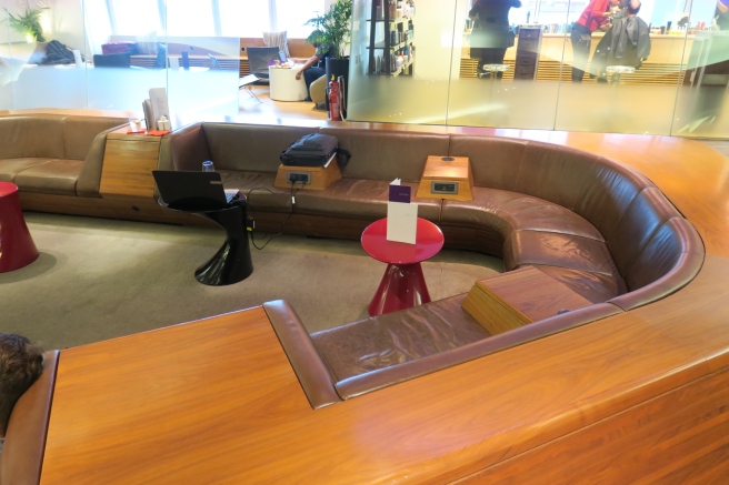 a brown couch and a red table