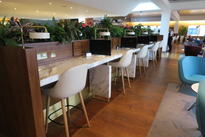 a room with a long table with chairs and computers