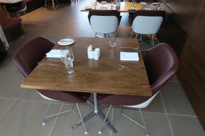 a table with chairs and glasses