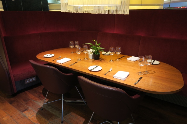 a table with wine glasses and a plant on it