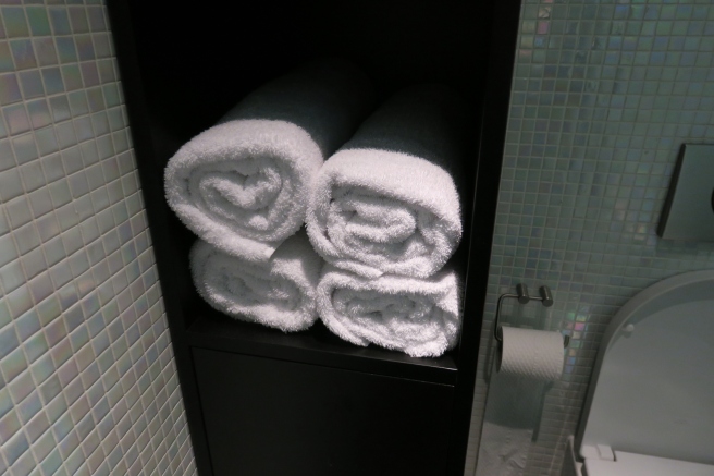 a stack of towels on a shelf