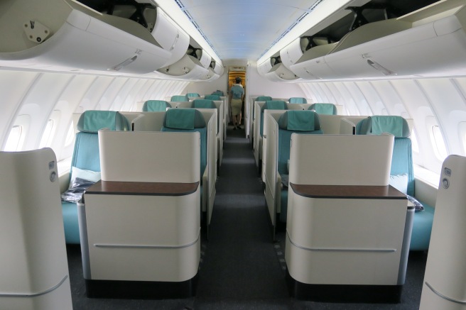 an inside of an airplane with rows of seats