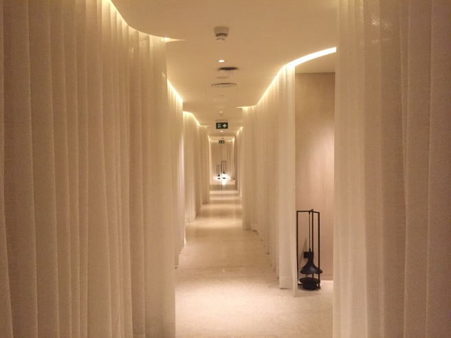 a long hallway with white curtains