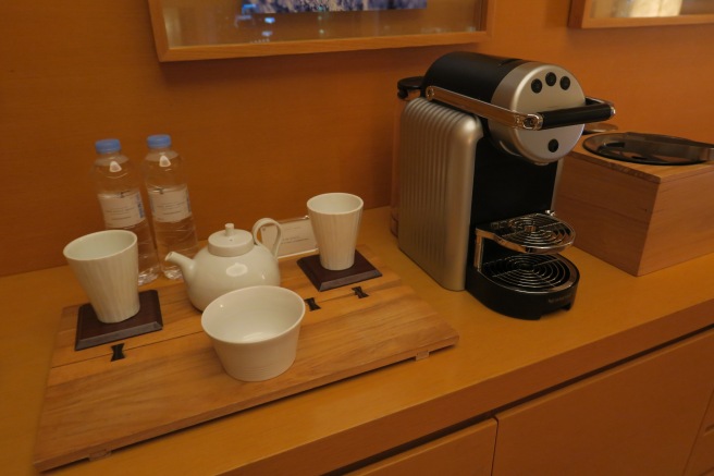 a coffee machine and cups on a table