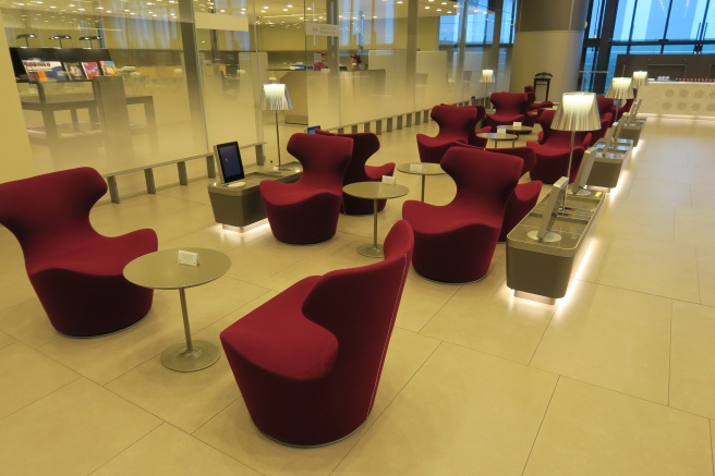 a room with red chairs and tables