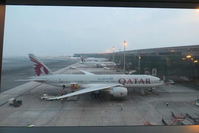 a group of airplanes parked at an airport