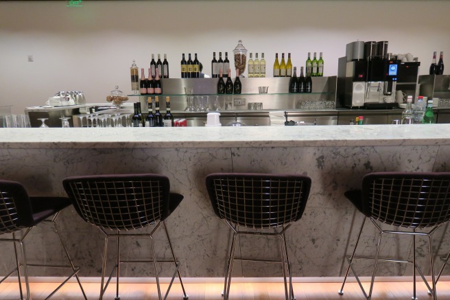 a bar with chairs and a counter