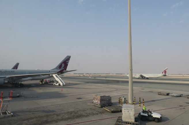 a group of airplanes on a runway