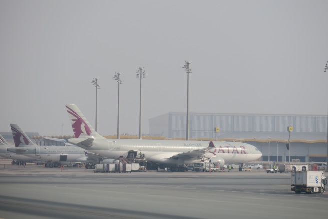 a group of airplanes at an airport