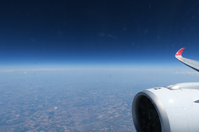 an airplane wing and blue sky