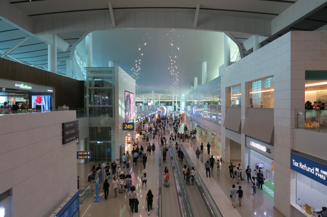 a group of people walking in a large airport