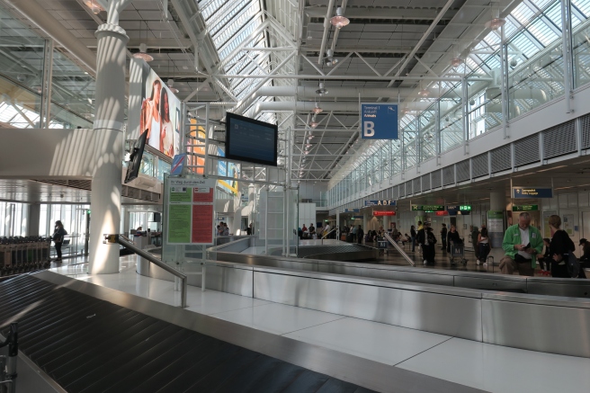 a large airport with a luggage carousel