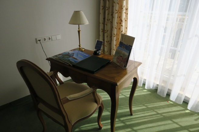 a desk with a lamp and a book on it