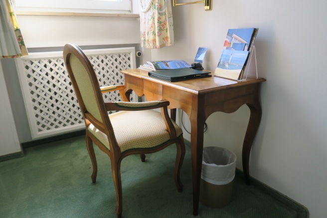 a desk with a laptop and a chair