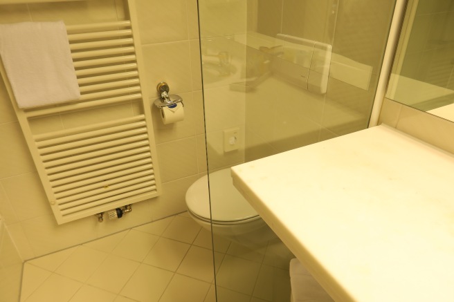 a bathroom with a glass shower door