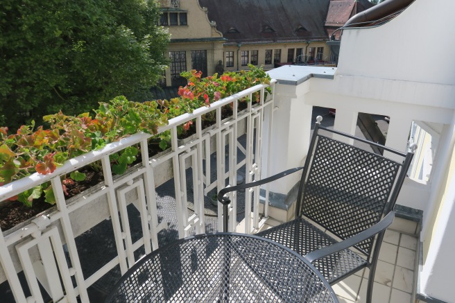 a chair and table on a balcony