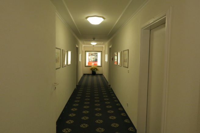 a hallway with pictures on the wall