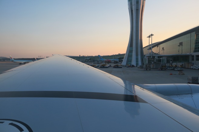 an airplane wing in front of a tower