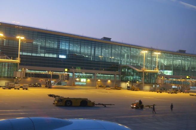 a large building with lights and cars