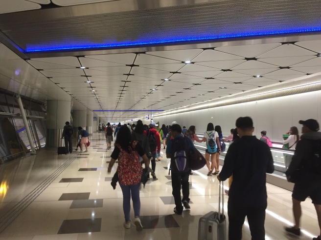 a group of people walking in a hallway