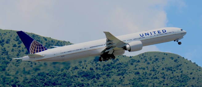 a large white airplane flying in the sky