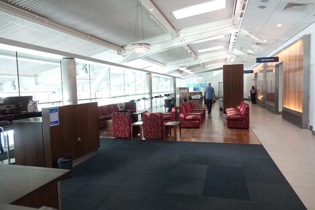 a room with red couches and tables