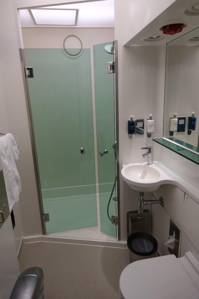 a bathroom with a glass shower and sink