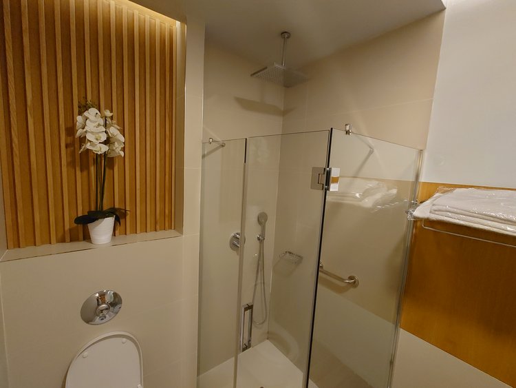 a bathroom with a glass shower and toilet