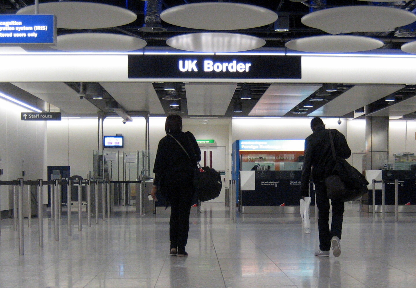 a group of people walking in a airport