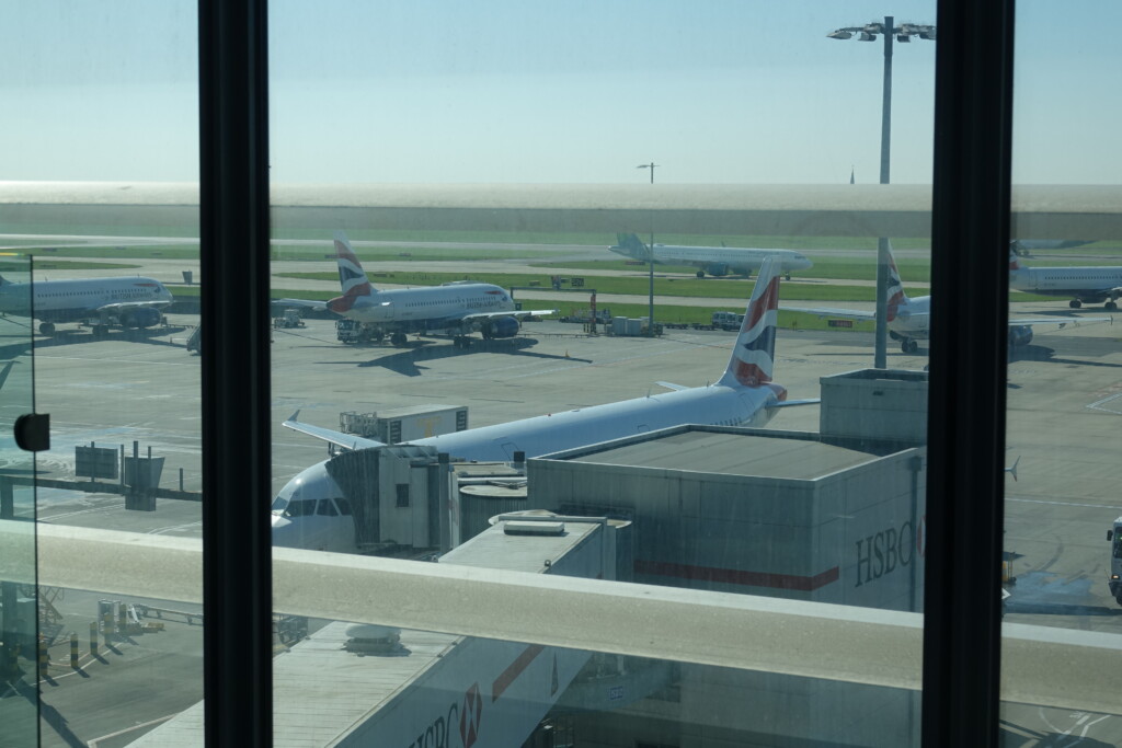 a group of airplanes parked at an airport